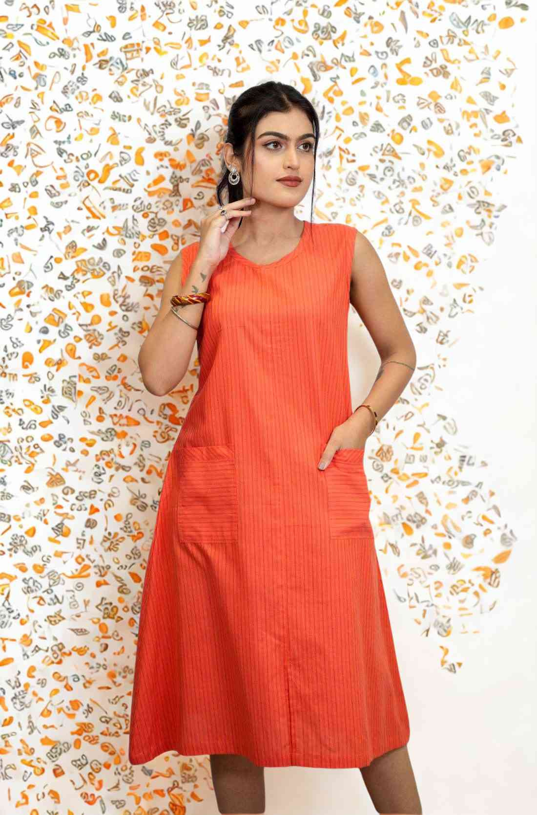 Close-up of pocket on sleeveless orange aline kurta