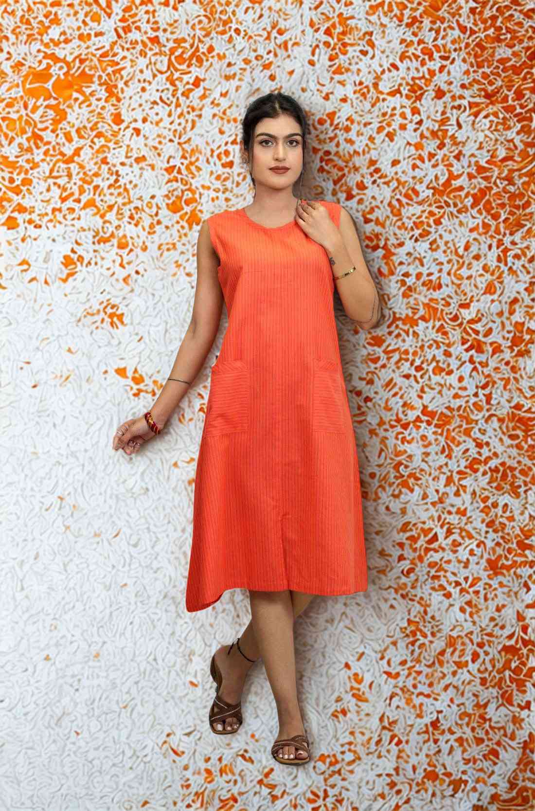 Walking shot in orange striped A-line kurti