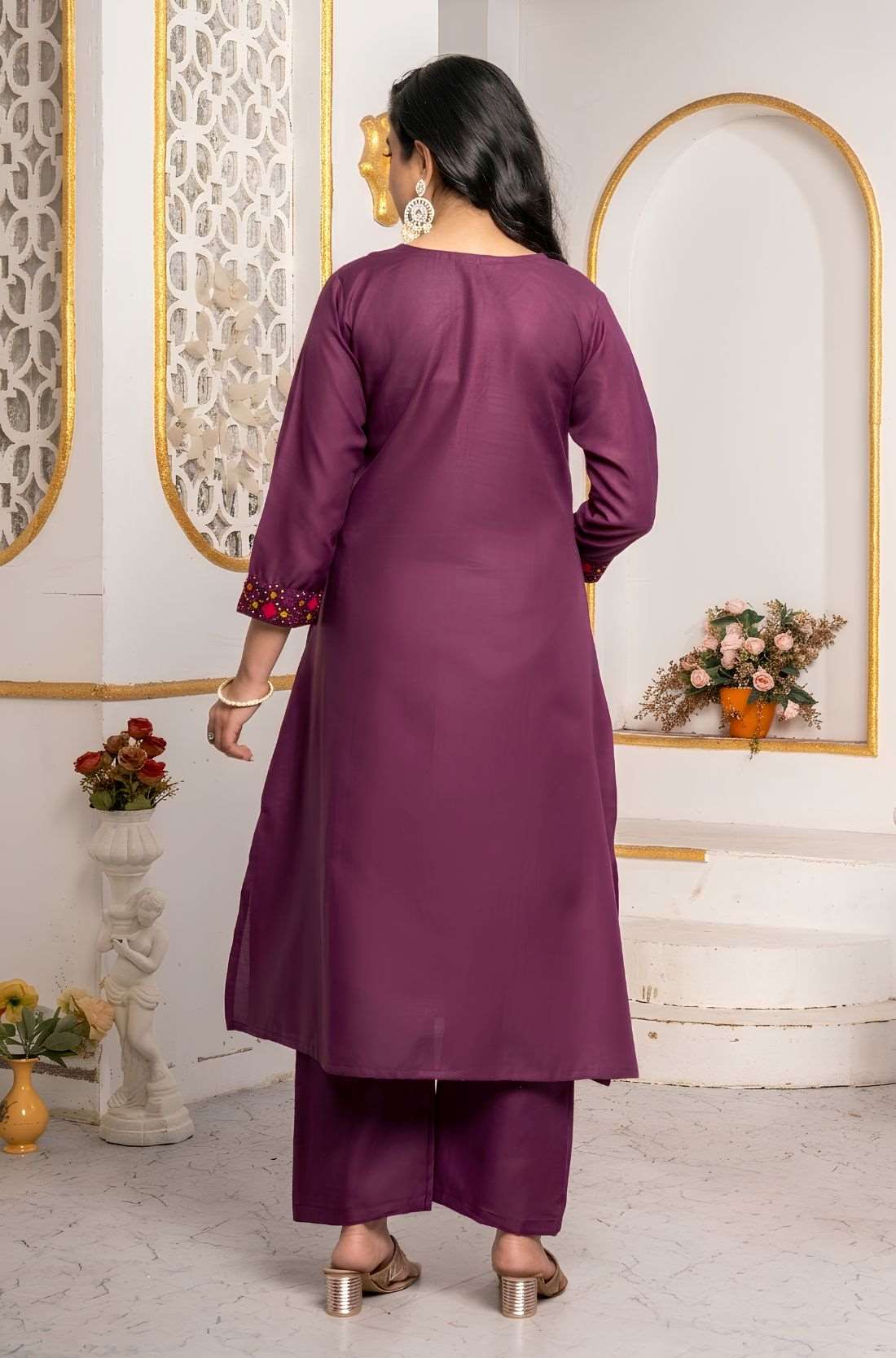 Back view of a magenta pure cotton kurta pant set showing the plain kurta silhouette, three-quarter sleeves with embroidered cuffs and matching straight-fit pants.