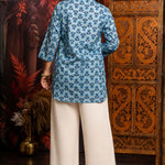 Back view of women's powder blue short kurti made from pure cotton featuring all-over hand block floral print, relaxed fit and hip-length design.