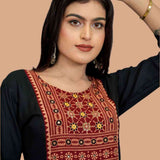 Black hand enbroidery and block print detail on yoke showing front view.