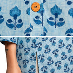 Detailed view of powder blue pure cotton short kurti highlighting handcrafted floral block print, wooden button closure and side slit for ease of movement.