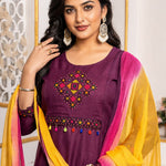 Close-up of a magenta pure cotton kurta featuring a round neckline and intricate multicolour geometric cross-stitch embroidery with mirror detailing, paired with an ombre chiffon dupatta.