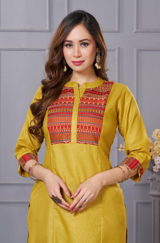 A high-detail front shot of a mustard-yellow silk kurta - focusing on the red-toned ethnic embroidery - and the subtle sheen of the fabric.