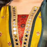 Detailed view of the mustard yellow Vichitra silk kurta neckline showcasing golden mirror work, a contrast Bandhani-print godet, dark green edging, and intricate embroidered floral motifs.