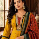 Close-up of a mustard yellow Vichitra silk kurta featuring a V-neckline with golden mirror work, contrast red Bandhani-print insert, delicate sequin and thread embroidery, and a printed Chanderi silk dupatta.