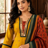 Close-up of a mustard yellow Vichitra silk kurta featuring a V-neckline with golden mirror work, contrast red Bandhani-print insert, delicate sequin and thread embroidery, and a printed Chanderi silk dupatta.