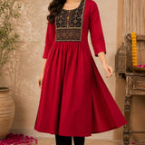 Woman wearing a maroon rayon A-line kurta with an embroidered yoke, showing the flare of the kurta