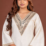 Off white Vatican silk A-line kurta set for women, front view showing geometric mirror work on the V-neckline and flared sleeves with gold trim.
