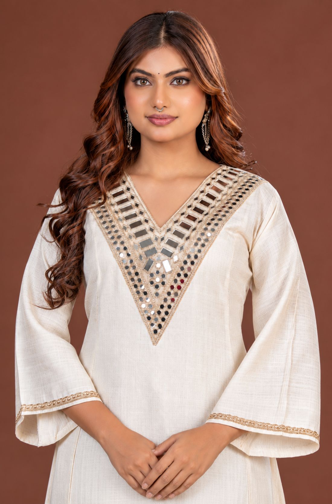 Off white Vatican silk A-line kurta set for women, front view showing geometric mirror work on the V-neckline and flared sleeves with gold trim.