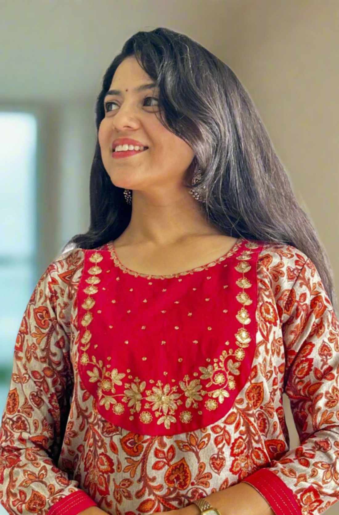 Close-up of a red pashmina kurta set with an embroidered neckline.
