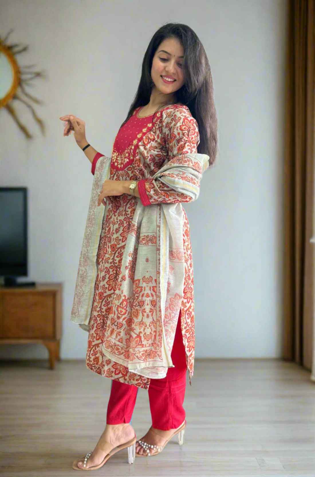 Side pose in red pashmina kurta with white dupatta.