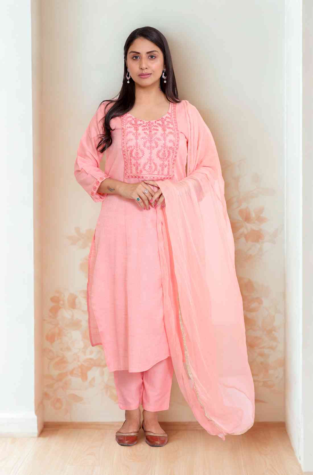 Full view of peach colour kurta set with matching footwear.