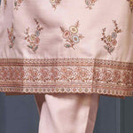Close-up of pastel kurta set scalloped embroidered border on light pink kurta hem.