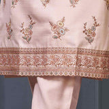Close-up of pastel kurta set scalloped embroidered border on light pink kurta hem.