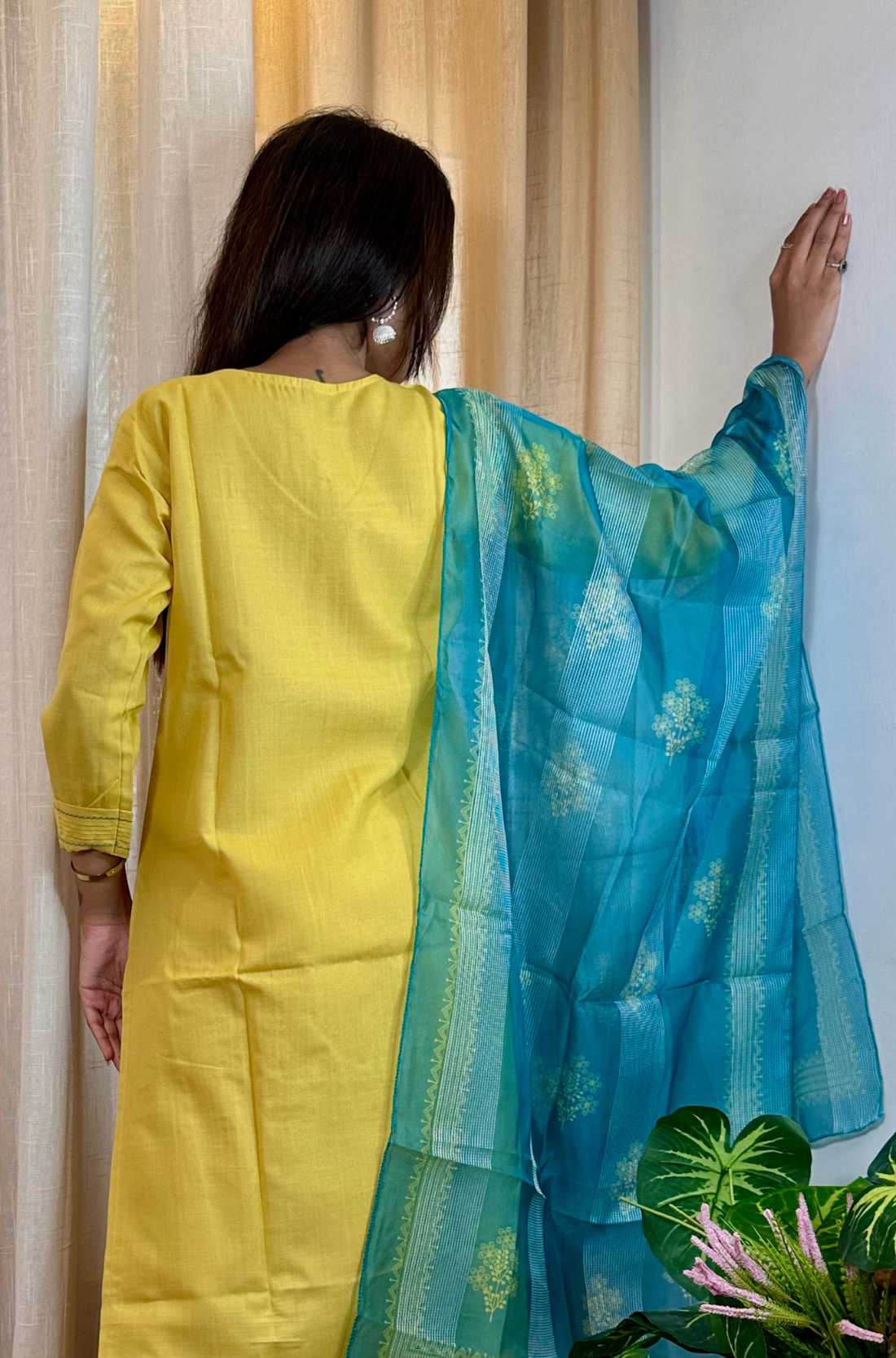 Back close up view  of yellow kurta set and blue printed dupatta