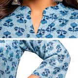 Close-up of powder blue pure cotton hand block printed short kurti featuring mandarin notch neckline, wooden buttons, floral block print and 3/4 sleeves.
