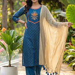 Front view of a women's royal blue straight-fit crepe kurta set with decorative floral yoke, matching trousers and gold dupatta.