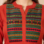 Close-up of a rust orange 100% pure cotton straight kurta featuring a V-neck, round collar, and multicoloured hand-embroidered yoke