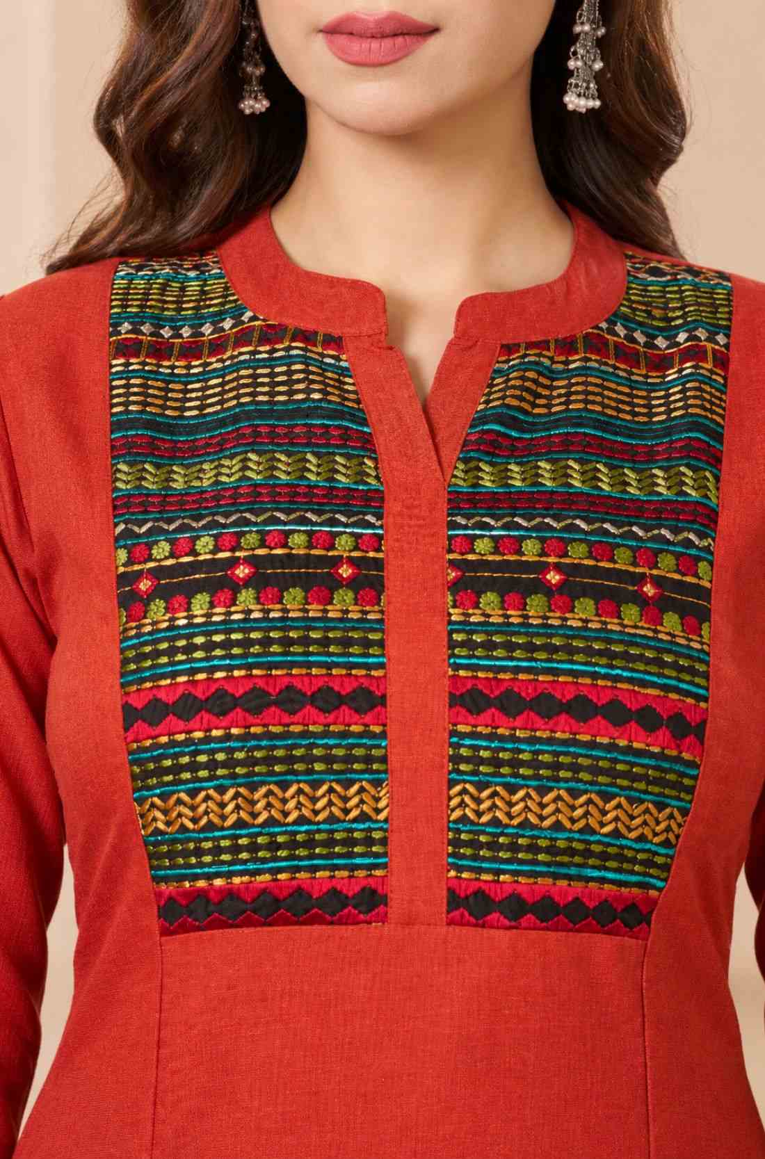 Close-up of a rust orange 100% pure cotton straight kurta featuring a V-neck, round collar, and multicoloured hand-embroidered yoke