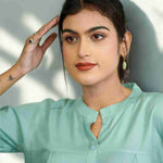 Close-up of the mandarin collar, front button placket, and elegant pleated detailing on a women's sea green rayon formal Top.