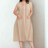 Front view of women's beige cotton striped frock style Kurti featuring a round neckline, sleeveless design, vertical stripes, two front pockets, and a relaxed A-line silhouette for everyday wear.