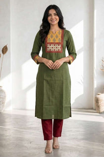 Full front view of women's dark green cotton kurti featuring a hand block print patch yoke, three-quarter sleeves, straight fit, and calf-length design styled with maroon pants.