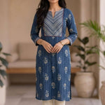 Front view of women's indigo pure cotton straight-fit kurta featuring a round neckline, diagonal striped contrast yoke with red piping, white floral hand block print motifs, and three-quarter sleeves.