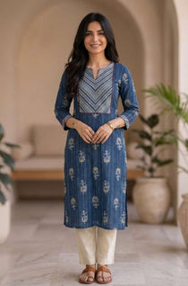 Front view of women's indigo pure cotton straight-fit kurta featuring a round neckline, diagonal striped contrast yoke with red piping, white floral hand block print motifs, and three-quarter sleeves.
