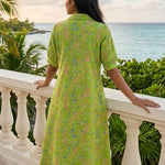 Back view of women's lime green pure cotton frock style dress with collar neckline, elbow sleeves, Jaipur floral print, Kantha stitch detailing, and A-line silhouette.
