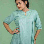 Half-length front view of women's sea green rayon Top featuring a mandarin collar, button-down front, subtle pleats, and relaxed fit for office and casual styling.