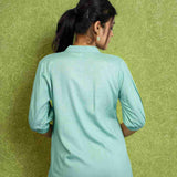 Back view of women's sea green rayon Top with a mandarin collar, half sleeves, relaxed silhouette, and smooth back design for office and casual wear.