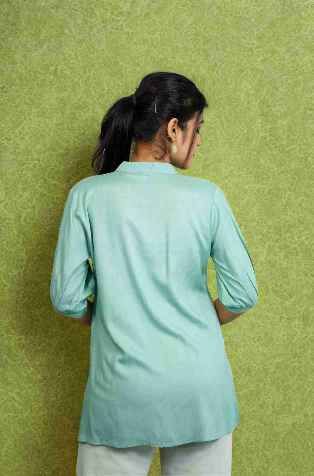 Back view of women's sea green rayon Top with a mandarin collar, half sleeves, relaxed silhouette, and smooth back design for office and casual wear.