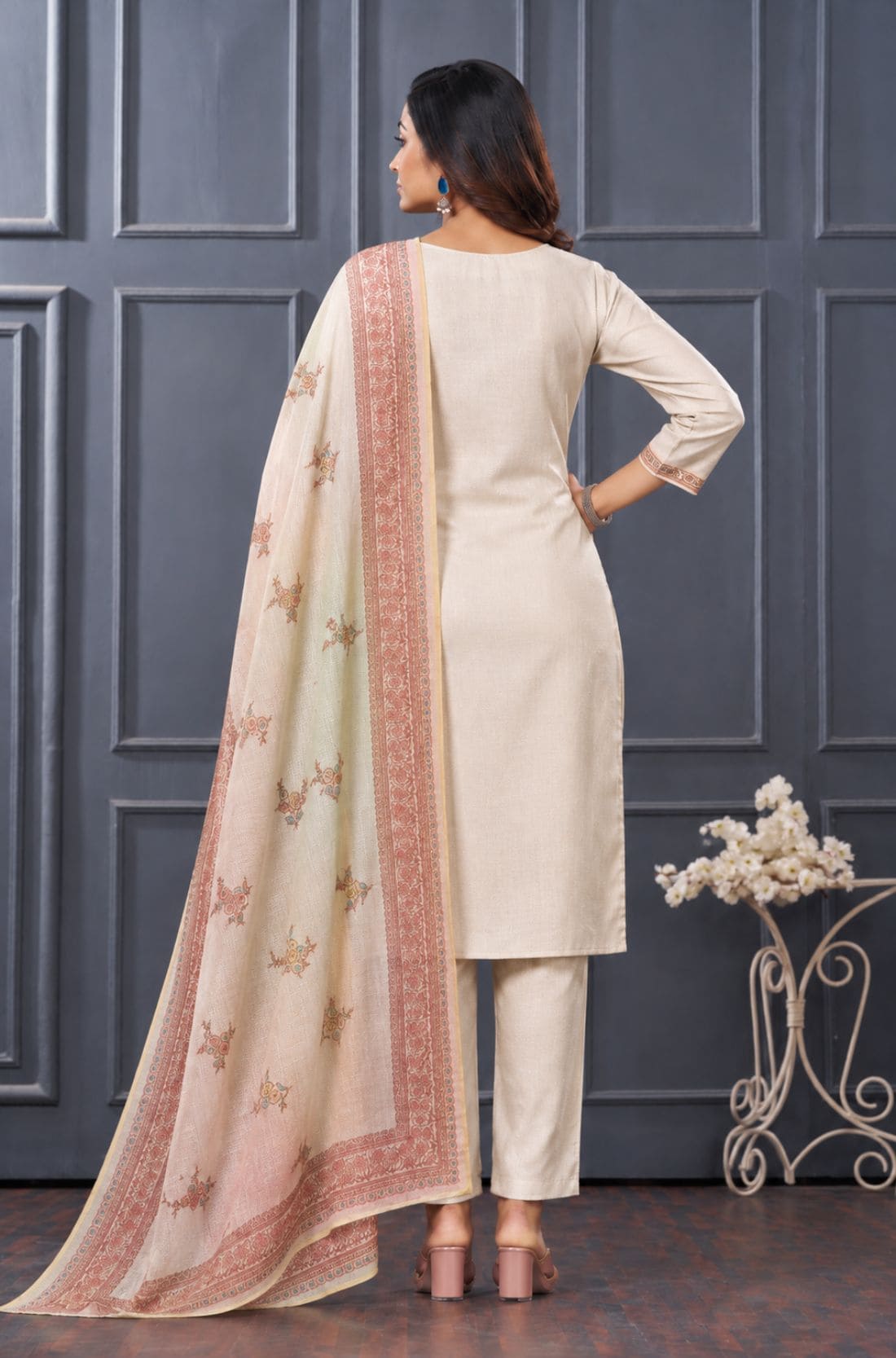 Back view of women’s beige 3-piece silk blend kurta set with matching pants and printed dupatta.