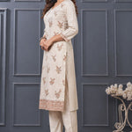 Side view of women’s beige embroidered silk blend kurta set with matching pants.