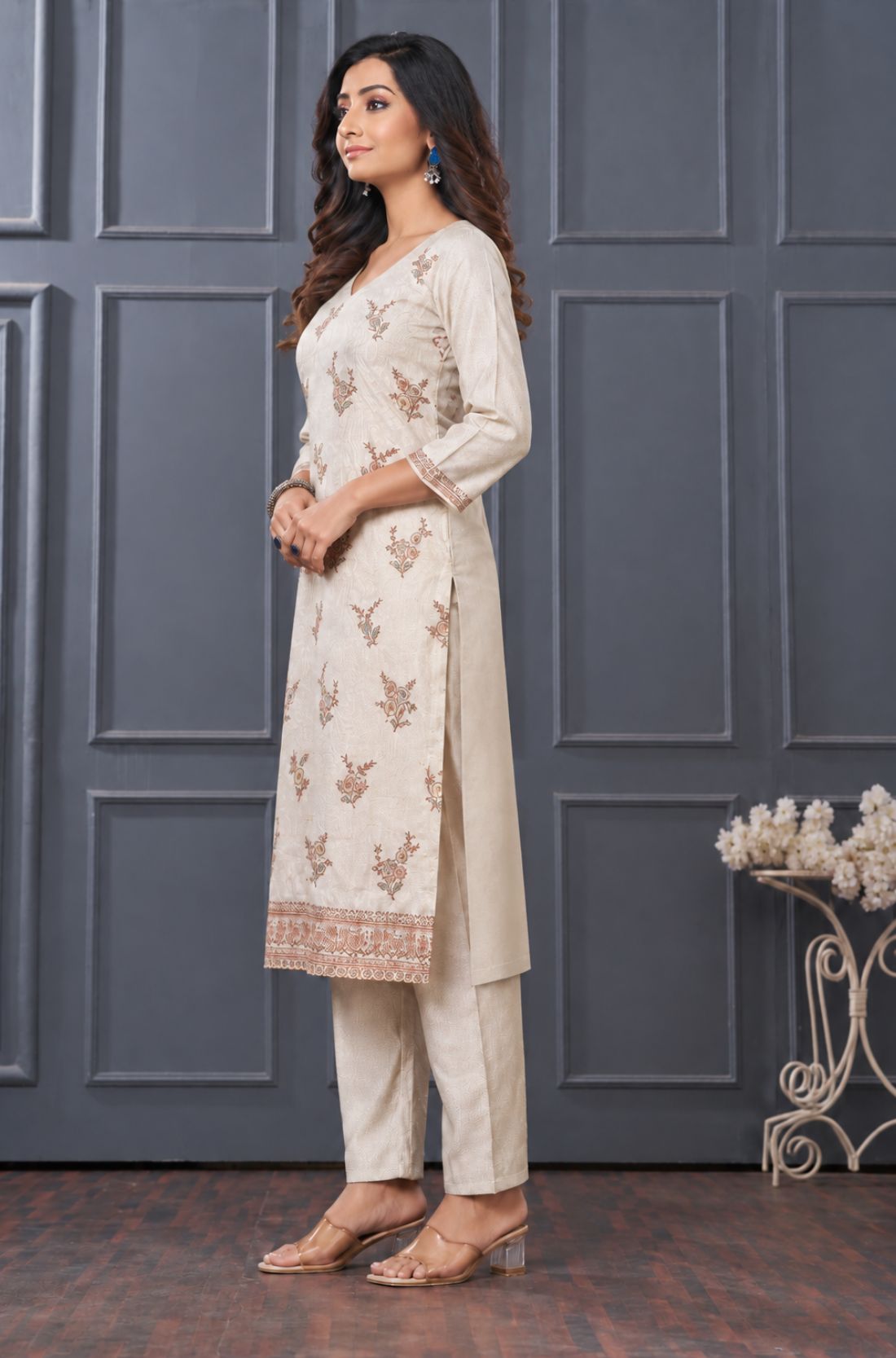 Side view of women’s beige embroidered silk blend kurta set with matching pants.