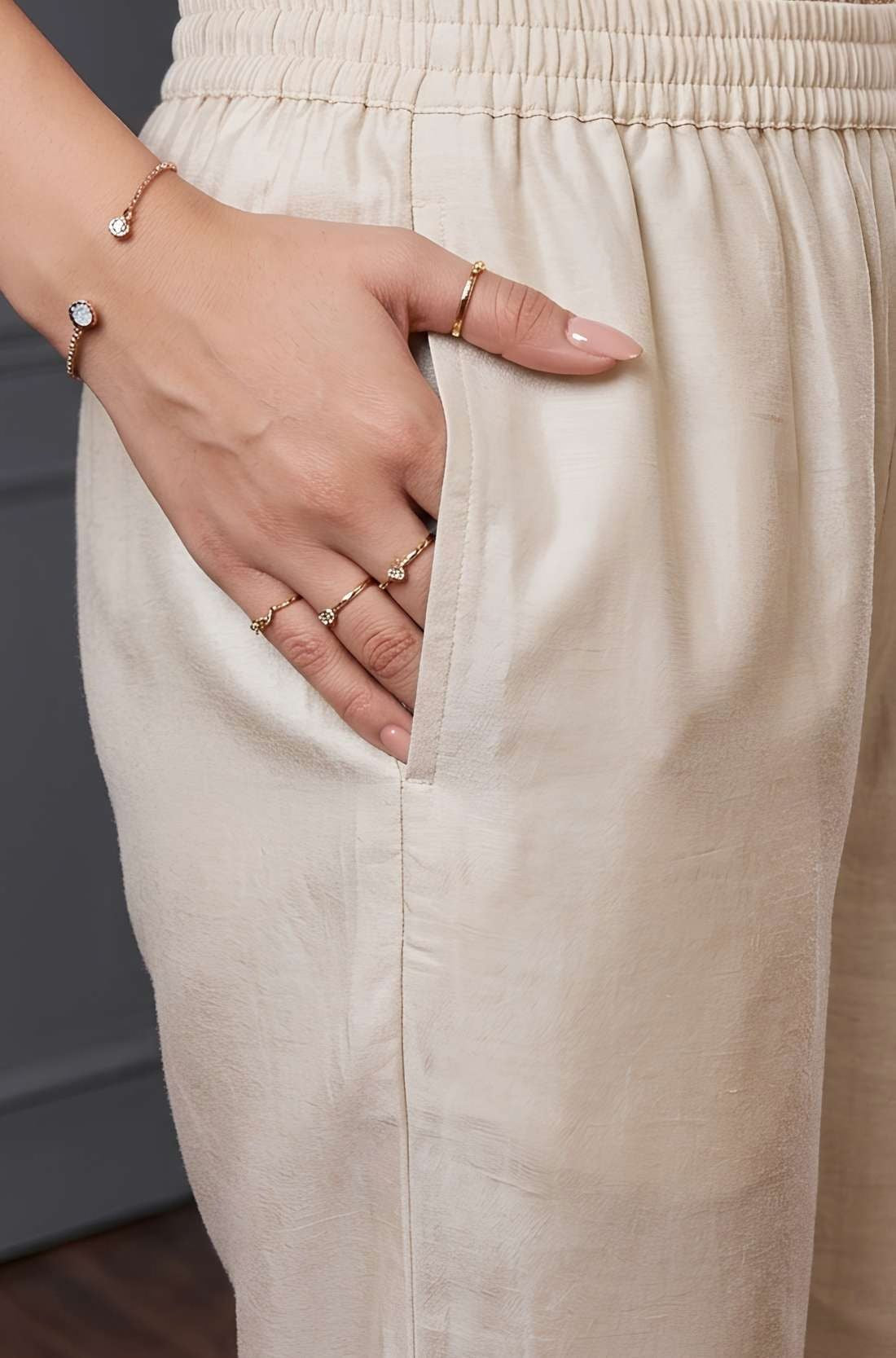 Close-up of the side pocket and elasticated waistband of beige pants from a women’s kurta set.