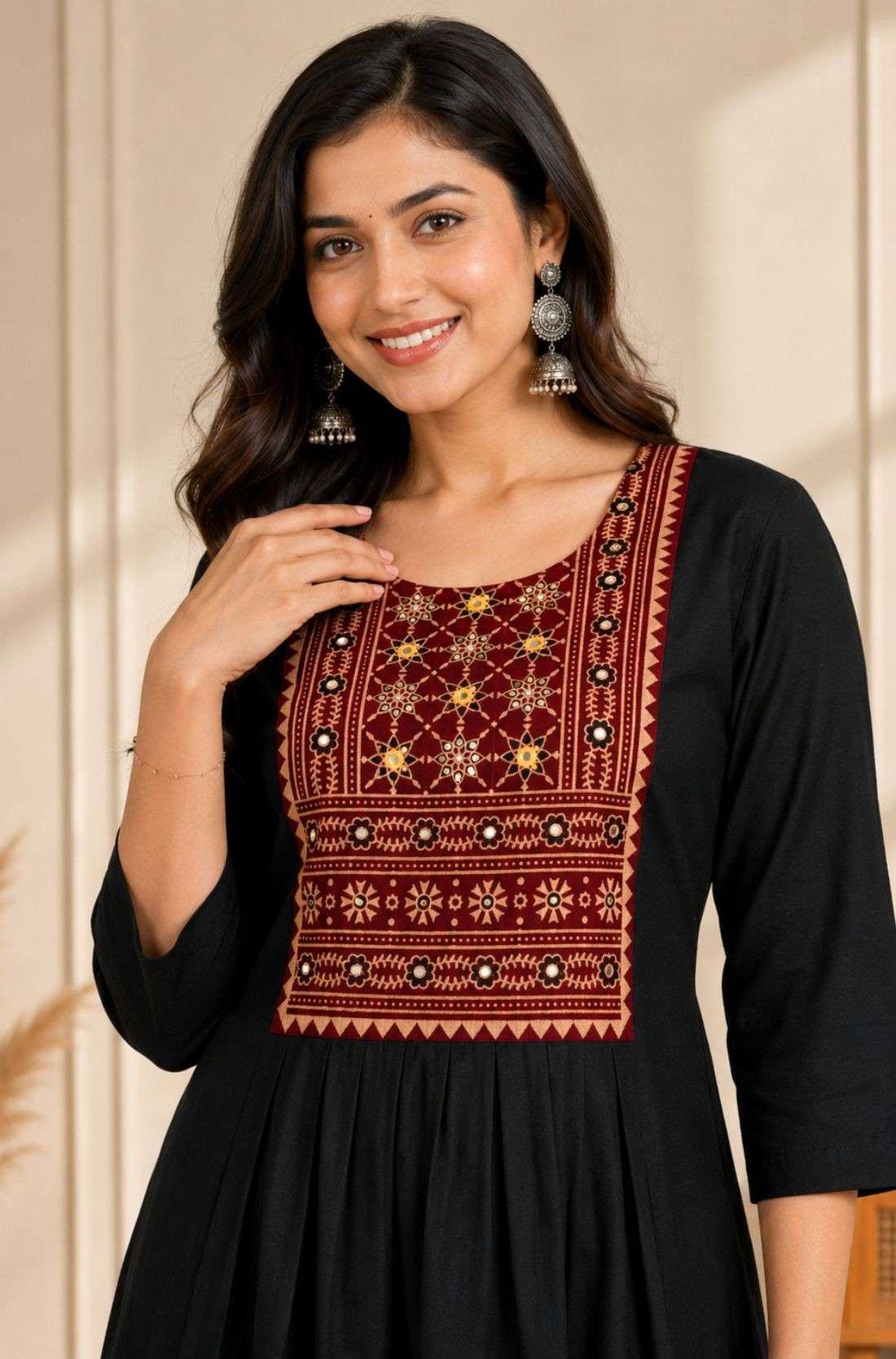 Close-up of hand embroidery, mirror work and block print yoke on black rayon kurta