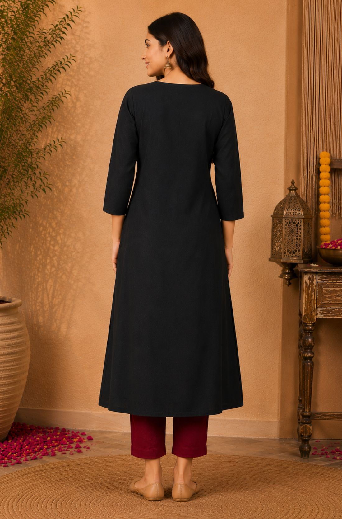 Full back view of black rayon A-line kurta showing the plain back, three-quarter sleeves and flared hem