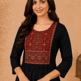 Close-up of black rayon kurta with hand embroidery, block print and mirror work on the front yoke