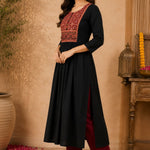 Side-angle view of black rayon A-line kurta with embroidered front yoke, three-quarter sleeves and flared hem