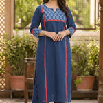 Full length front view of a woman posing gracefully in a blue ethnic wear set with floral print details.
