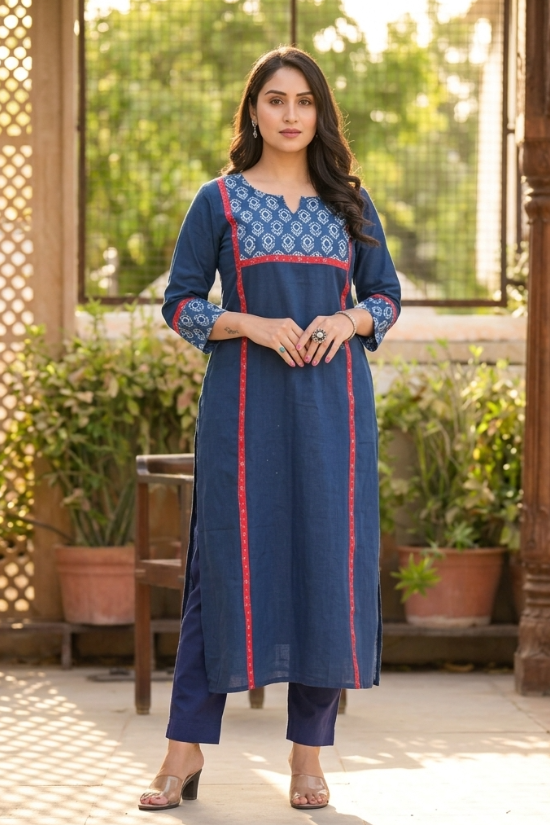 Full length front view of a woman posing gracefully in a blue ethnic wear set with floral print details.