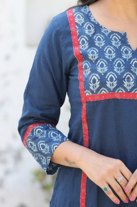 Detail shot showcasing the matching floral block print on the sleeve cuffs and neckline of a blue kurti.