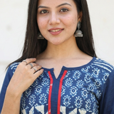 Portrait of a beautiful woman wearing a blue printed yoke kurti paired with traditional oxidised silver jhumkas.