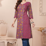 Side profile view of a model in a bright pink floral printed cotton ethnic suit showcasing the clean straight-cut fall and matching dupatta drape