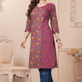 Side profile view of a model in a bright pink floral printed cotton ethnic suit showcasing the clean straight-cut fall and matching dupatta drape