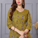 Close up view of the elegant neckline design showcasing white lace inserts and border trims on a sage green cotton floral print kurta
