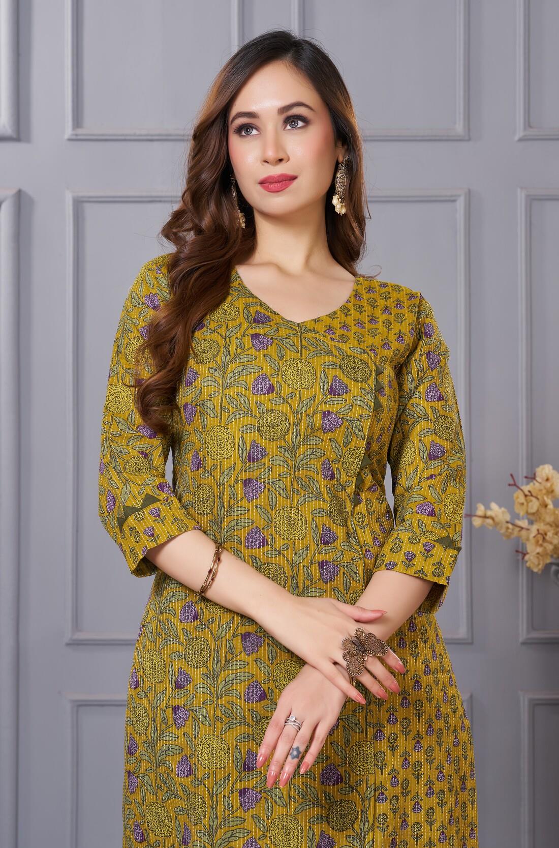 Close up view of the elegant neckline design showcasing white lace inserts and border trims on a sage green cotton floral print kurta