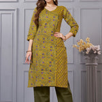 Front full length view of a model wearing a sage green cotton floral print kurta set with matching pocketed straight pants and a coordinating printed dupatta